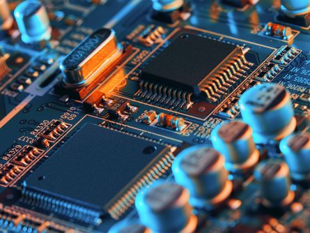 close up of electronic board with microchips and semiconductors